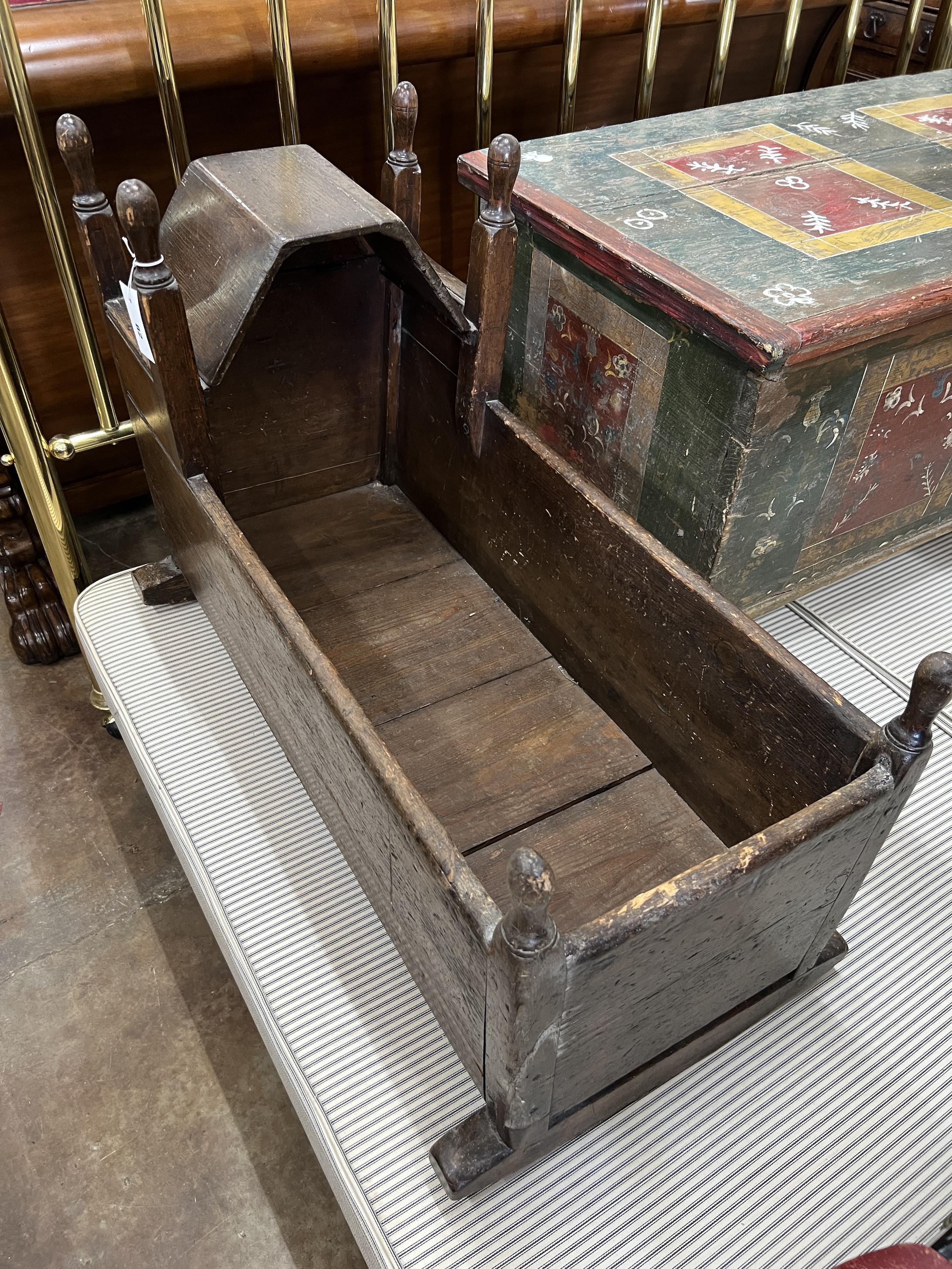 A 17th century style oak rocking crib, length 96cm, depth 39cm, height 64cm